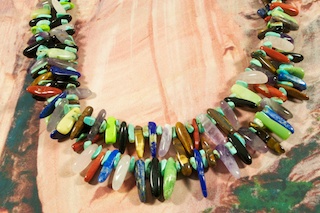 Stunning 2 strand Treasure Necklace with all the colors of the Painted Desert. Featuring Genuine Turquoise, Blue Lapis, Red Jasper, Picture Jasper, Black Onyx and Amethyst. Penshell Heishi, Sterling Silver Beads and Clasp. Created by Santo Domingo Artist Carol Pacheco. The Santo Domingo Pueblo is in New Mexico, near Santa Fe.